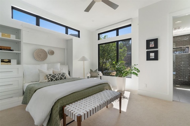 bedroom featuring ensuite bathroom, carpet flooring, ceiling fan, and visible vents