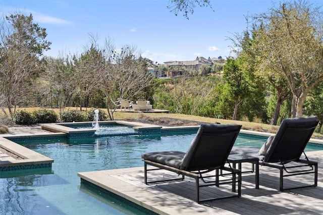 view of swimming pool with a pool with connected hot tub