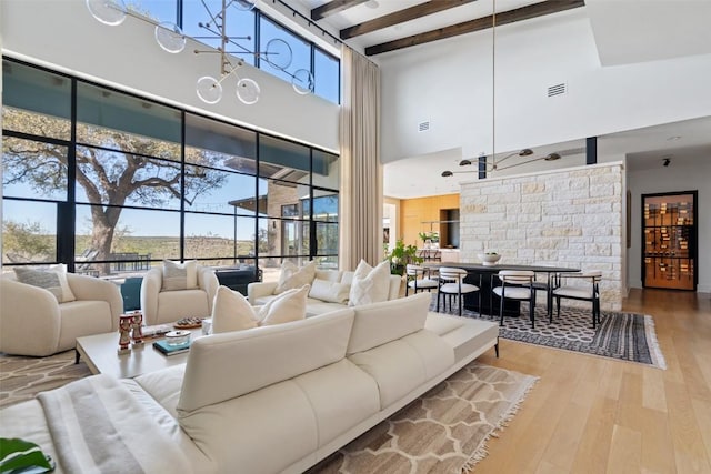 8701 Acuarela Ct, Austin, TX 78735 - living room with a high ceiling, hardwood / wood-style floors, and beam ceiling
