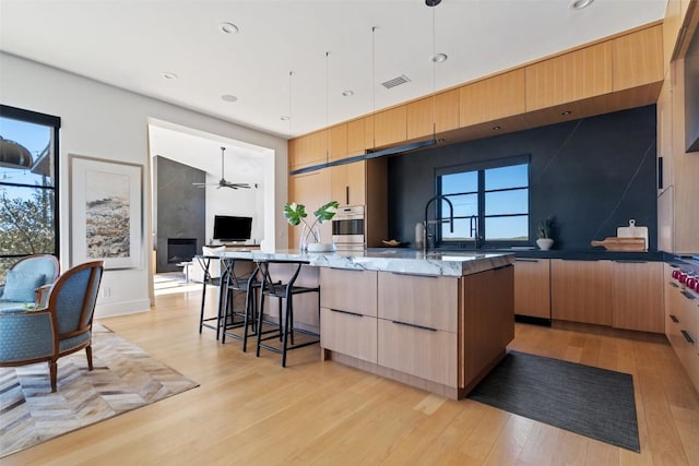 8701 Acuarela Ct, Austin, TX 78735 - kitchen featuring modern cabinets, light brown cabinetry, a ceiling fan, oven, and recessed lighting