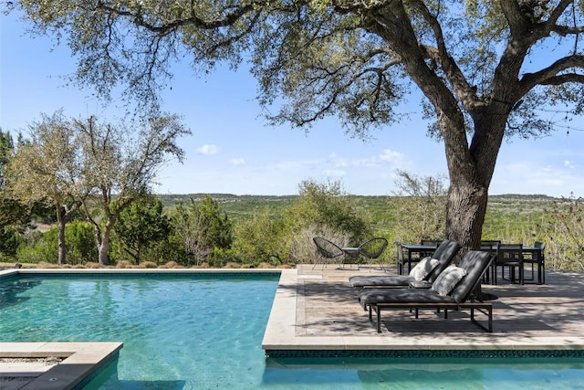 outdoor pool with a patio area