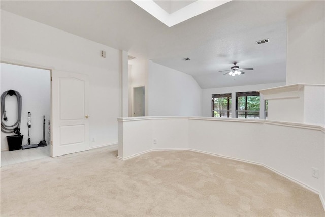 1202 Stepp Bnd, Cedar Park, TX 78613 - spare room featuring light colored carpet, a ceiling fan, lofted ceiling, a skylight, and baseboards