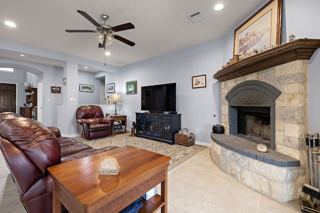 living area with arched walkways, a ceiling fan, recessed lighting, and visible vents