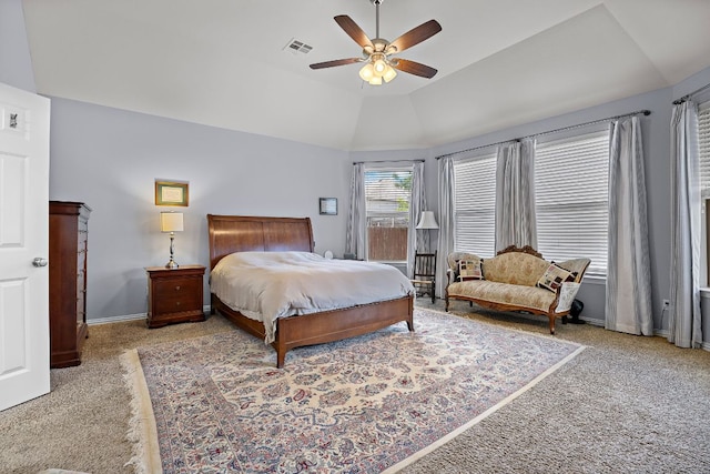 carpeted bedroom featuring a ceiling fan, baseboards, visible vents, and lofted ceiling