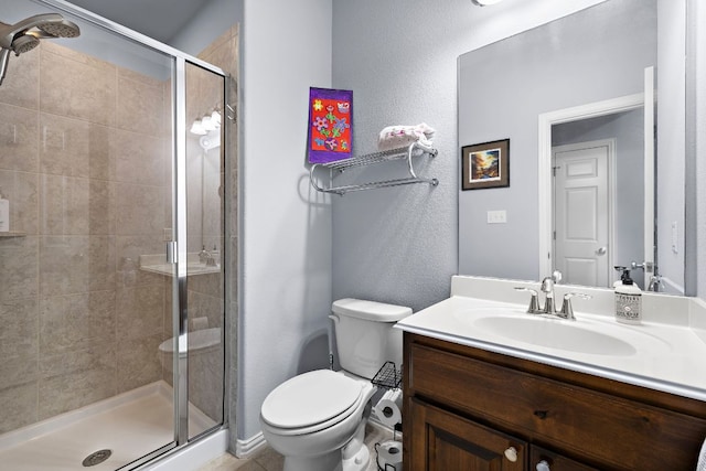full bathroom featuring vanity, toilet, and a shower stall