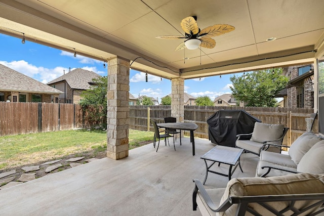 view of patio featuring a fenced backyard, ceiling fan, and grilling area