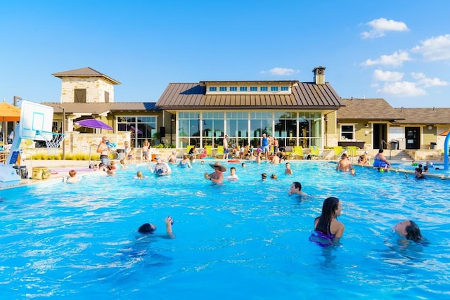 community pool with a sunroom