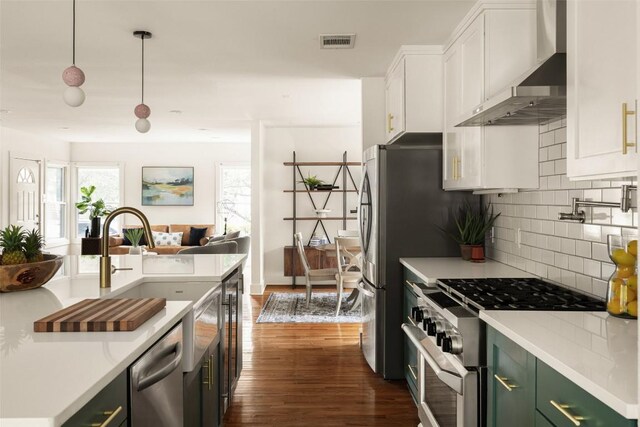 4903 Shoal Creek Blvd, Austin, TX 78756 - kitchen with appliances with stainless steel finishes, decorative backsplash, wall chimney exhaust hood, and white cabinets