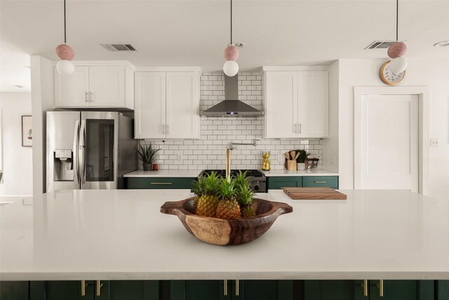 4903 Shoal Creek Blvd, Austin, TX 78756 - kitchen featuring visible vents, stainless steel fridge with ice dispenser, light countertops, wall chimney exhaust hood, and tasteful backsplash