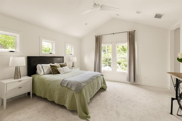 bedroom with a ceiling fan, light colored carpet, lofted ceiling, and visible vents