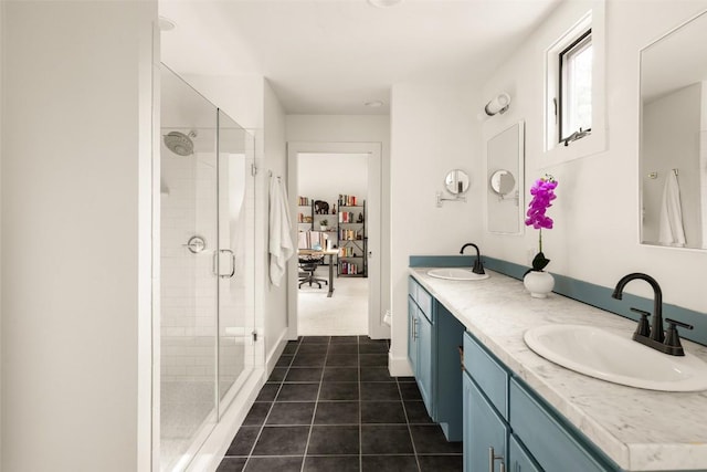 full bathroom featuring double vanity, a shower stall, and a sink