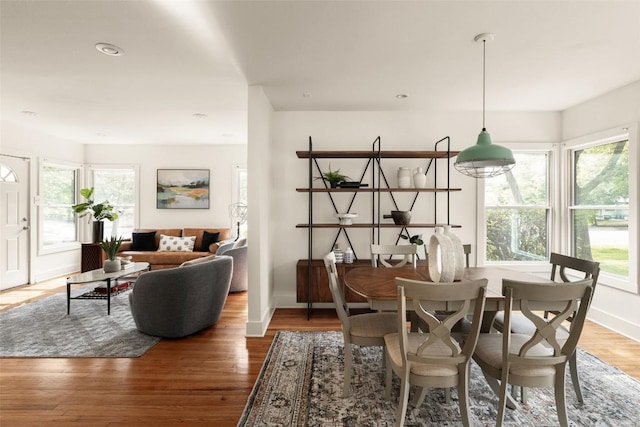 dining area featuring baseboards, recessed lighting, wood finished floors, and a wealth of natural light