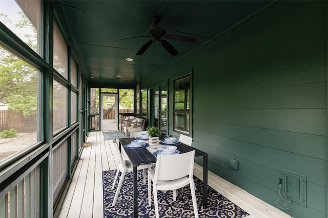 sunroom featuring a ceiling fan