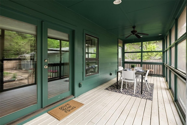 sunroom / solarium featuring outdoor dining area, ceiling fan, and a wealth of natural light