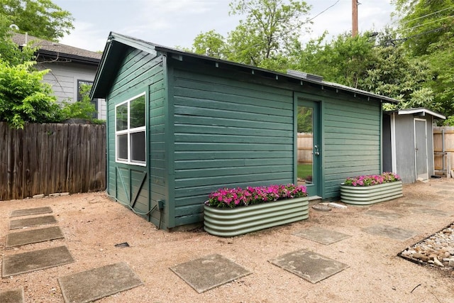 view of shed featuring fence