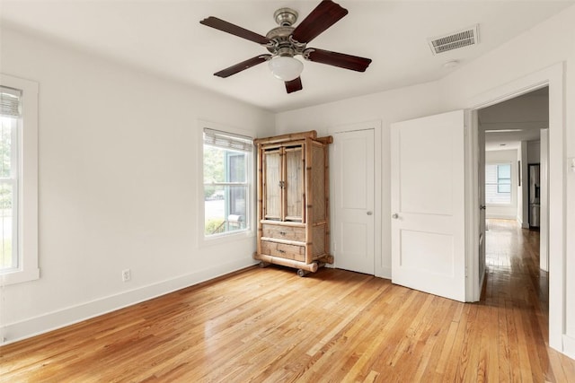 4903 Shoal Creek Blvd, Austin, TX 78756 - unfurnished bedroom featuring baseboards, multiple windows, light wood-style flooring, and visible vents