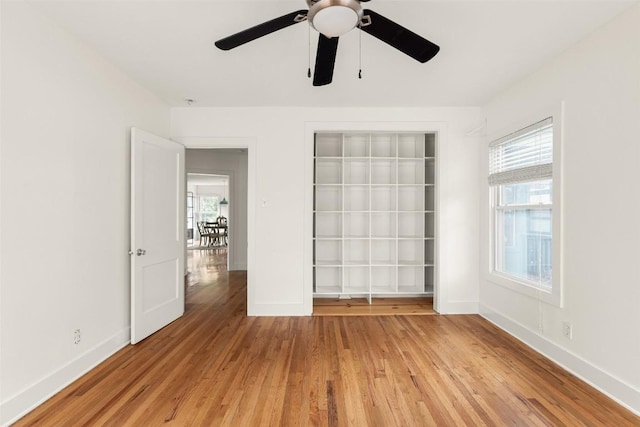 4903 Shoal Creek Blvd, Austin, TX 78756 - unfurnished bedroom featuring baseboards, ceiling fan, light wood-style flooring, and a closet