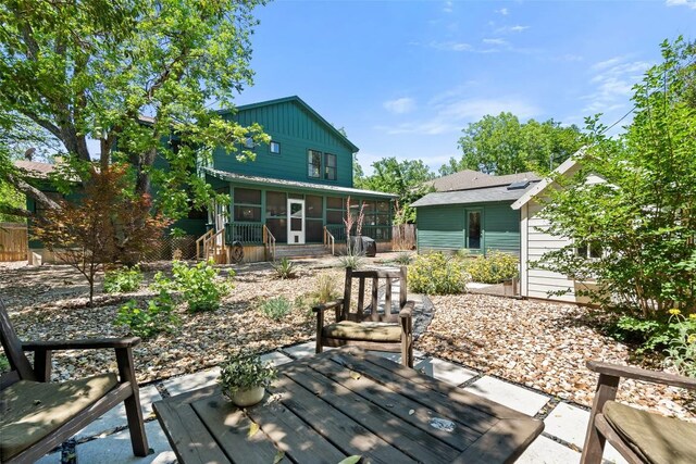 4903 Shoal Creek Blvd, Austin, TX 78756 - back of house with a sunroom, board and batten siding, and a patio area