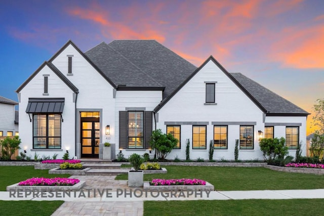 view of front of home with french doors and a front yard