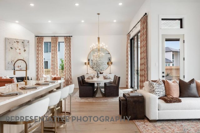 living area with recessed lighting, baseboards, a chandelier, and wood finished floors