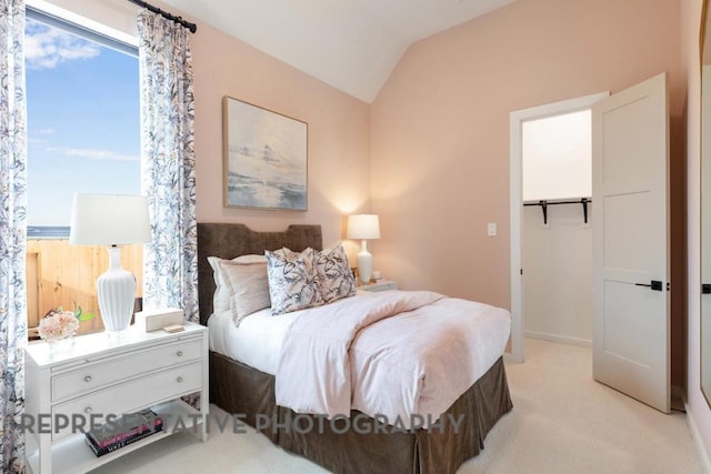 bedroom featuring light carpet and vaulted ceiling