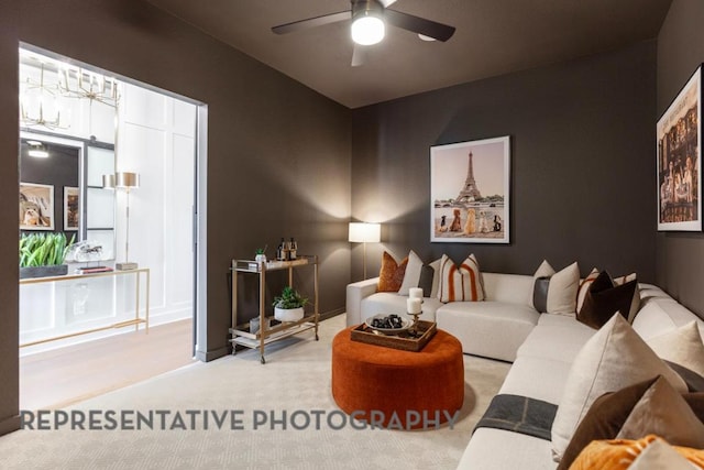 carpeted living area with a ceiling fan