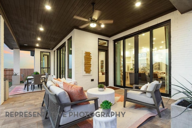 view of patio with fence, a ceiling fan, outdoor dining space, and outdoor lounge area