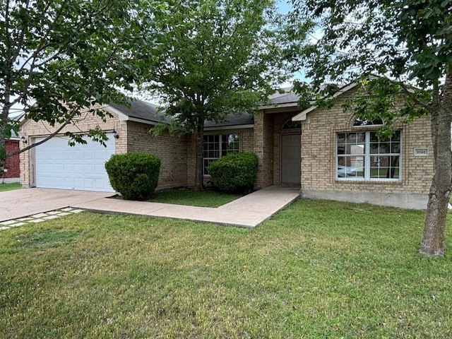 single story home featuring a garage, concrete driveway, brick siding, and a front yard