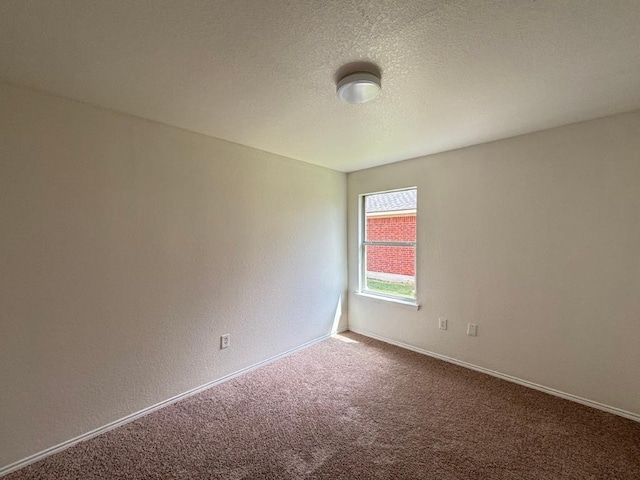 unfurnished room featuring baseboards and carpet