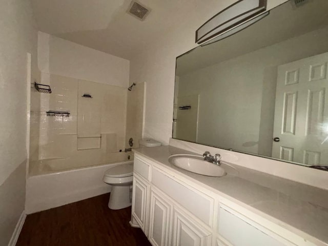 full bath with vanity, shower / bathtub combination, toilet, wood finished floors, and visible vents