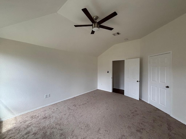 unfurnished bedroom with visible vents, baseboards, carpet floors, and lofted ceiling
