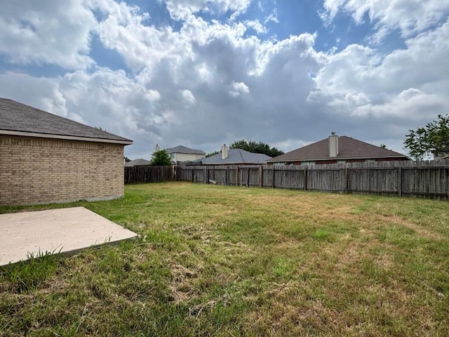view of yard featuring a patio and a fenced backyard