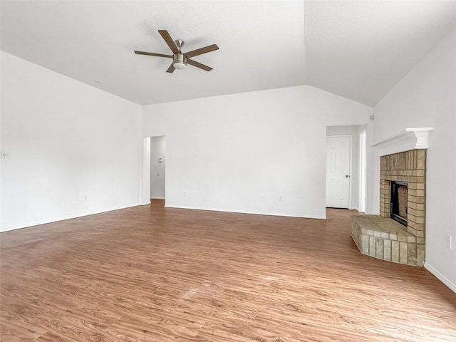1614 Prickly Pear St, Lockhart, TX 78644 - unfurnished living room with a ceiling fan, light wood finished floors, lofted ceiling, and a brick fireplace