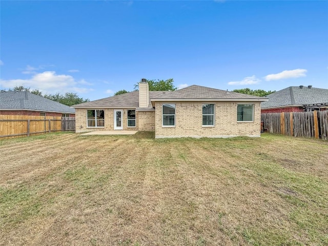 1614 Prickly Pear St, Lockhart, TX 78644 - back of property with brick siding, a chimney, a fenced backyard, and a patio area