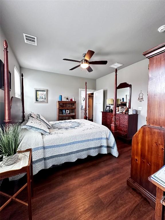 bedroom featuring visible vents, ceiling fan, and wood finished floors