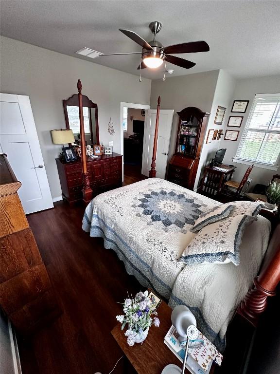 bedroom with visible vents, a ceiling fan, and wood finished floors