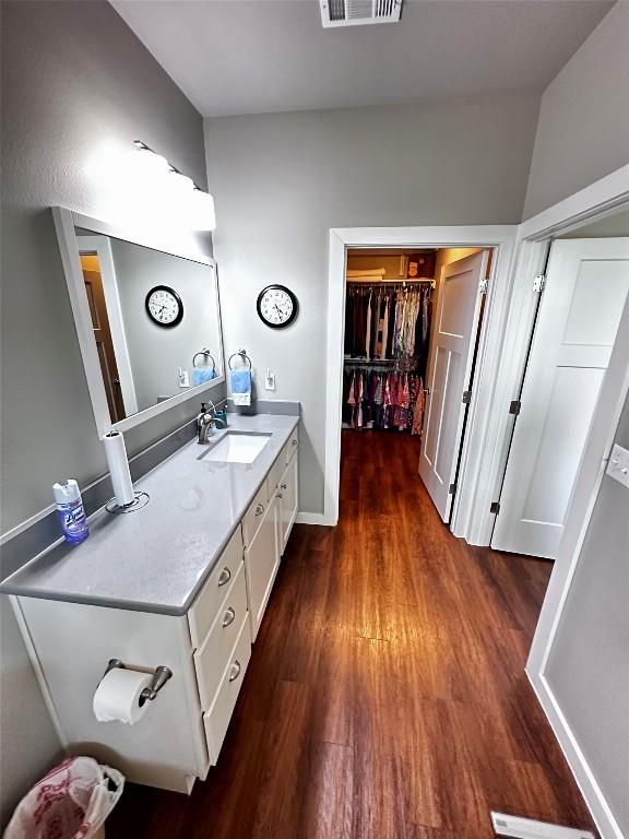 bathroom featuring vanity, wood finished floors, and visible vents