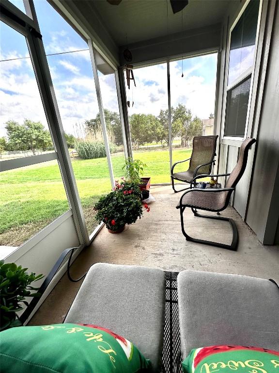 sunroom featuring a ceiling fan