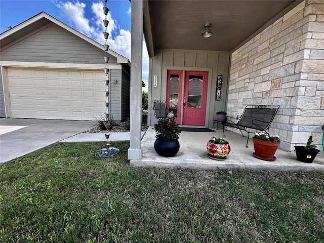 view of exterior entry featuring a garage and driveway