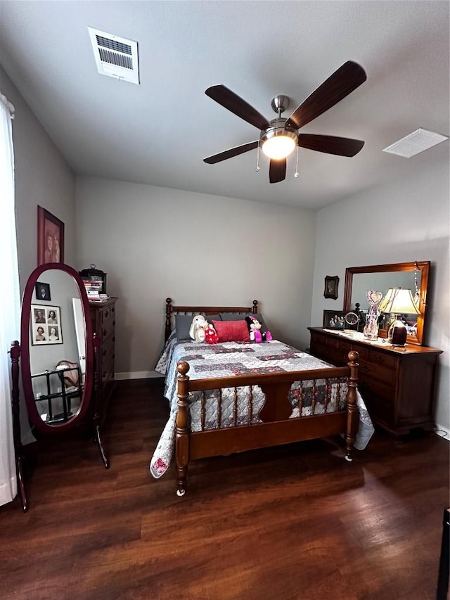 bedroom with visible vents, a ceiling fan, and dark wood-style flooring