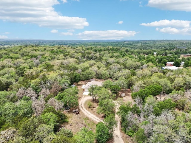 drone / aerial view featuring a forest view