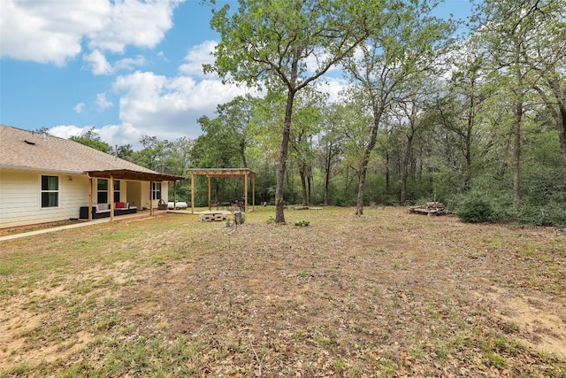 view of yard featuring a patio, a fire pit, and a pergola
