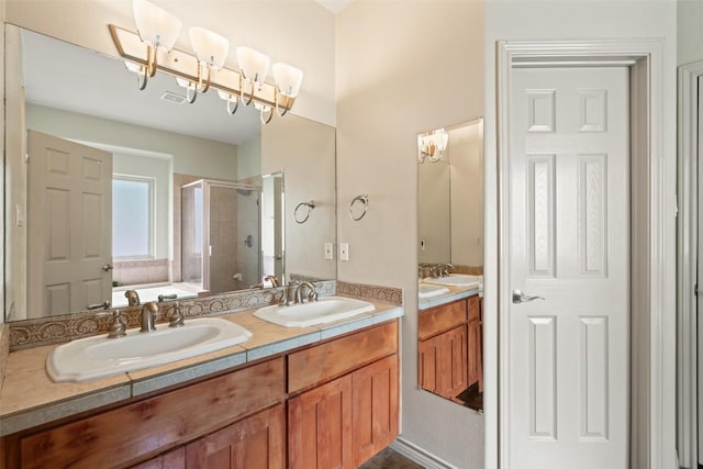bathroom featuring a garden tub, a sink, a stall shower, and double vanity