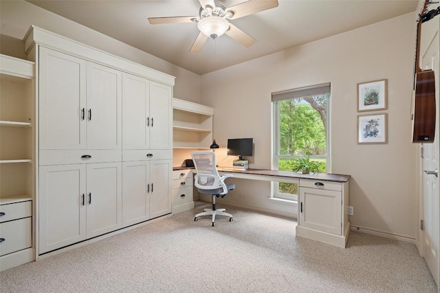 home office with ceiling fan, light colored carpet, and baseboards