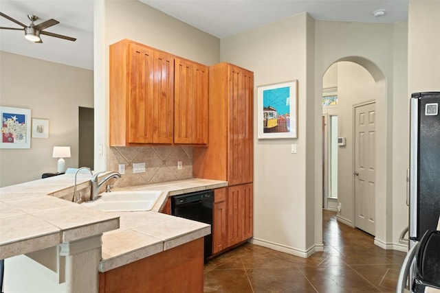 15205 N Flamingo Dr, Austin, TX 78734 - kitchen with black dishwasher, a peninsula, ceiling fan, a sink, and arched walkways