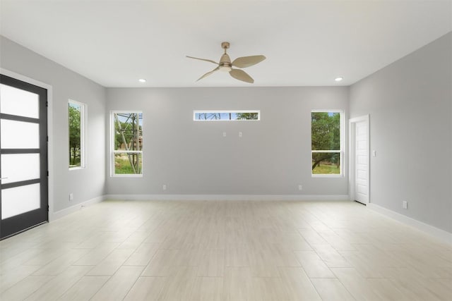 empty room featuring recessed lighting, a ceiling fan, and baseboards