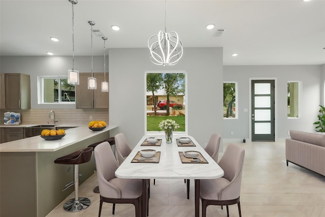 dining room featuring recessed lighting, visible vents, a healthy amount of sunlight, and an inviting chandelier
