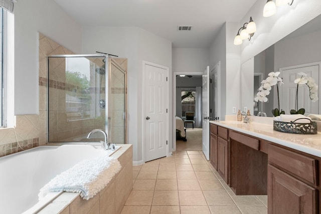 ensuite bathroom with vanity, tile patterned flooring, a shower stall, and a bath