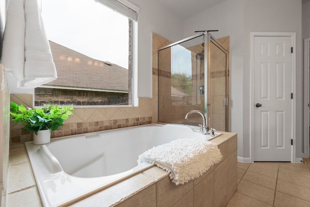 bathroom with tile patterned floors, a shower stall, and a bath