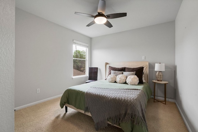 carpeted bedroom featuring a ceiling fan and baseboards